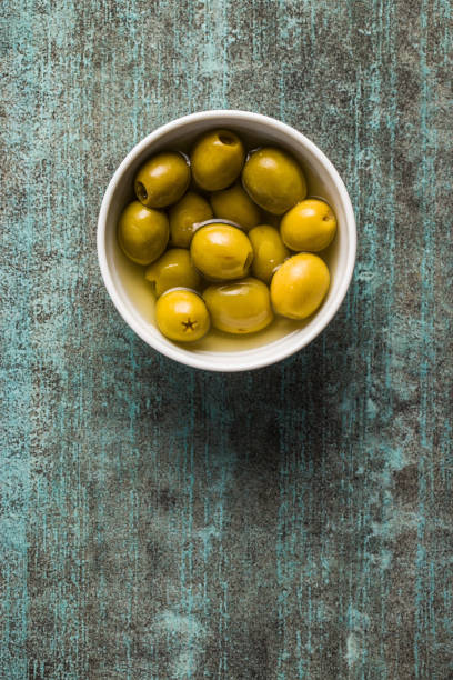 istock Marinated green olives in bowl. 1138805655