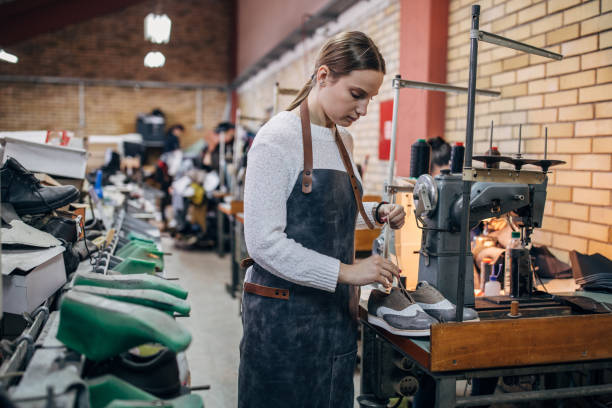 istock Young woman working in shoe factory 1138806698