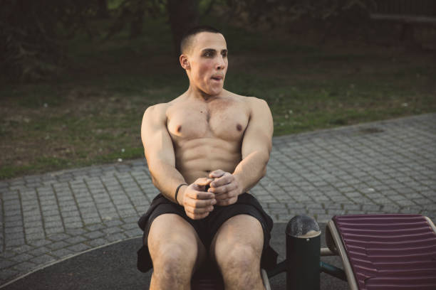 istock Young Muscular Man Exercising in Public Park 1138807536