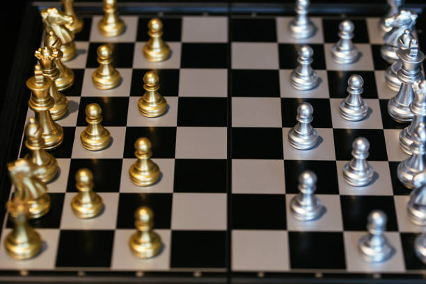 istock Golden and silver chess pieces on chess board 1138808760