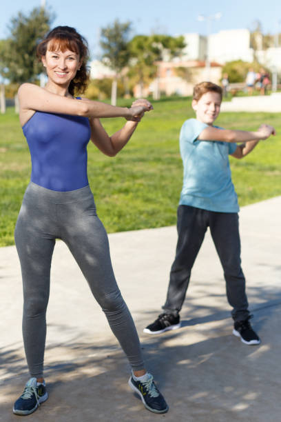 istock Mother and son stretching outdoors 1138809204