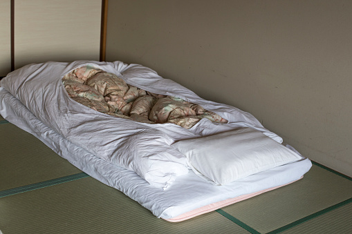 Japanese traditional bed on tatami mats in japanese traditional hotel