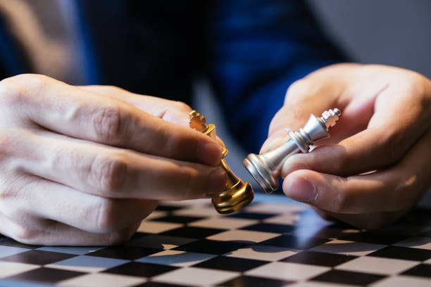 Cropped image of businessman made chess pieces fight