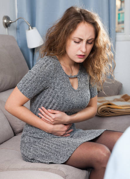 istock Unhappy woman having stomachache 1138810479