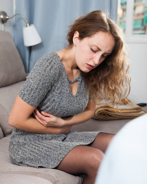 istock Unhappy woman having stomachache 1138810484