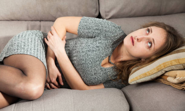 istock Portrait of girl with stomach problems 1138810492