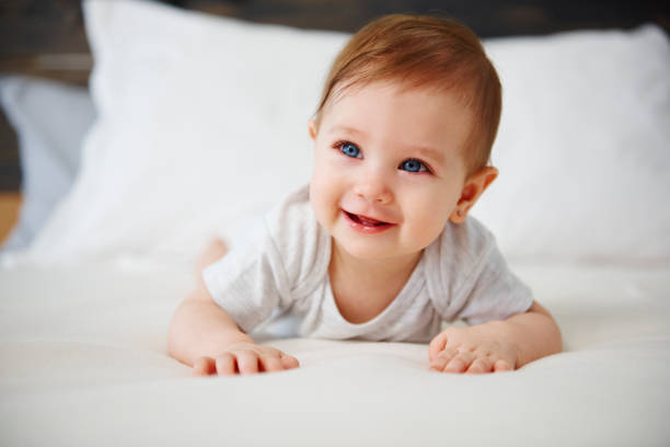 istock Charming baby lying on the bed 1138810503