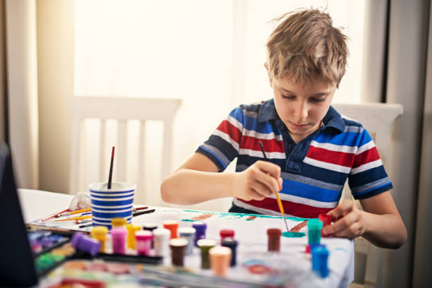 istock Little boy painting at home 1138810506