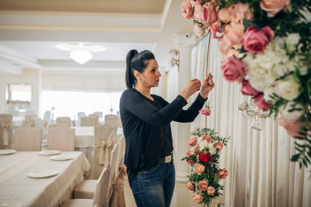 istock Woman arranging flowers for wedding celebration 1138810547