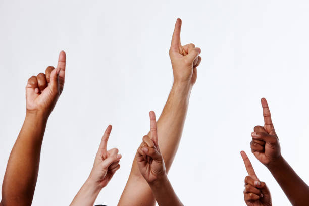 istock Mixed group of hands pointing upwards urgently 1138811141