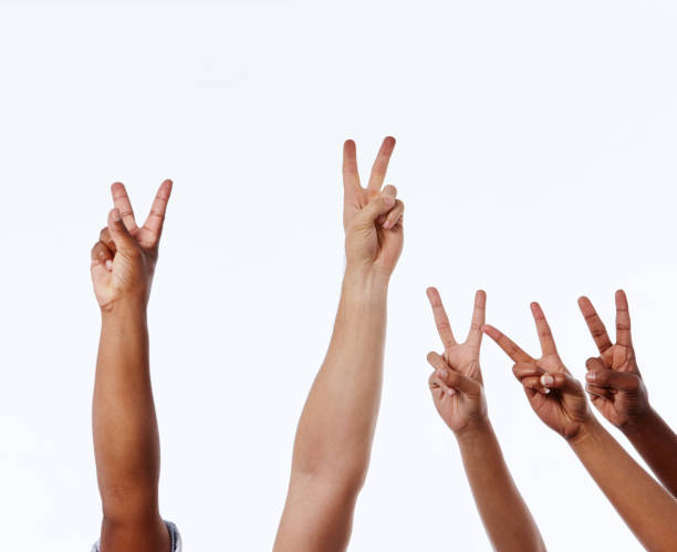 istock Mixed group of raised hands make Peace or Victory V-sign 1138812644