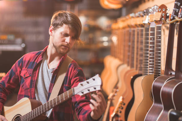 istock Young musician in the store 1138813627