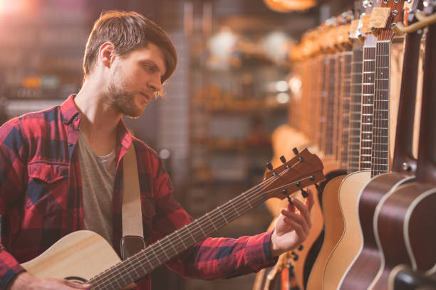 istock Young musician playing the guitar 1138813628