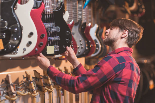 istock Young man choosing a guitar 1138813635