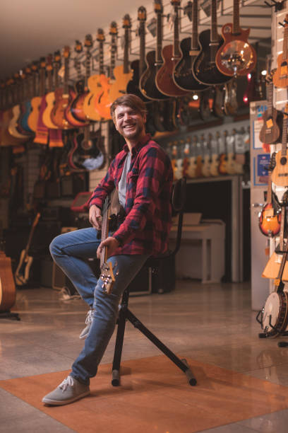 istock Young musician in the store 1138813667