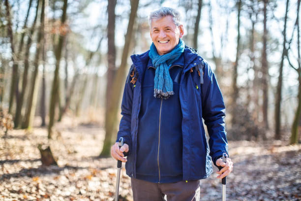 istock Senior man nordic walking through forest 1138813720