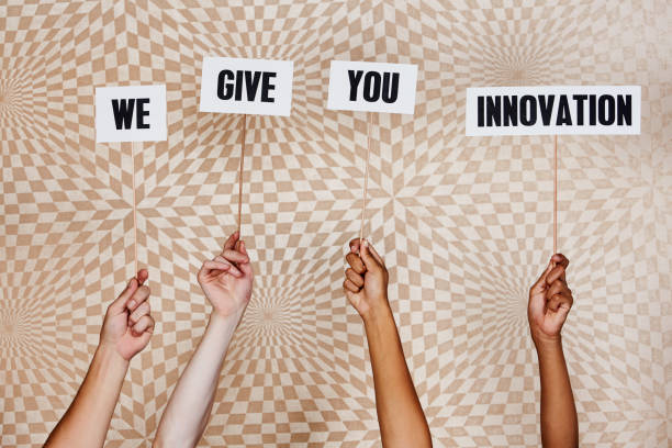 istock Four raised hands hold signs 