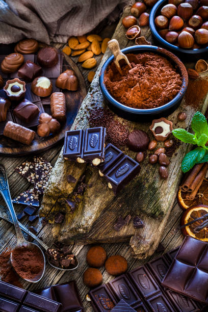 istock Chocolate assortment on cocoa powder shot from above on rustic wooden table 1138814051