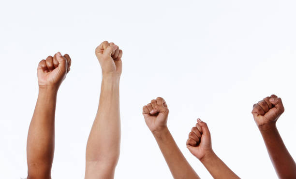 istock Mixed group of raised clenched fists make power salutes 1138814196