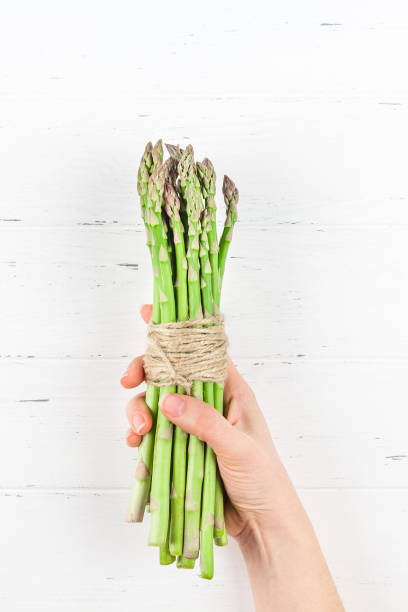 istock Fresh green asparagus in woman hands 1138814364