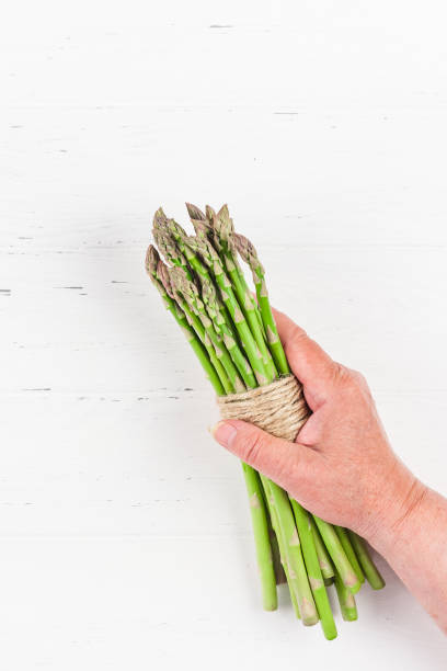 istock Fresh green asparagus in woman hands 1138814462