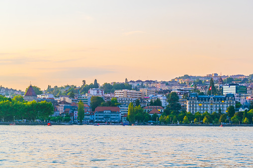 Ouchy part of Lausanne viewed from the Geneva lake during sunset, Switzerland