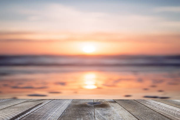 istock Empty wooden table and beautiful ocean with sunset. 1138816120