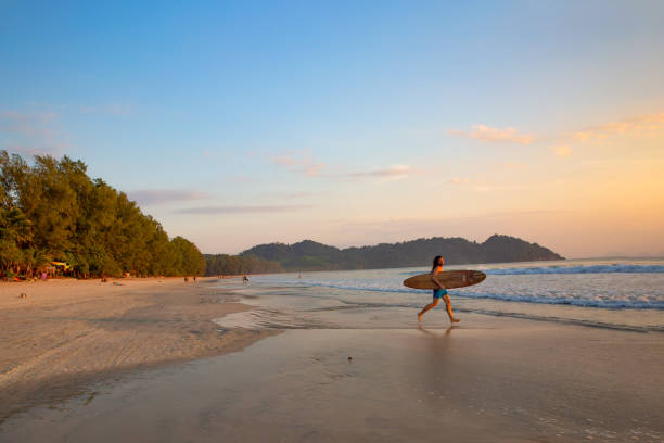 istock Surfer Runs towards the Sunset 1138819510