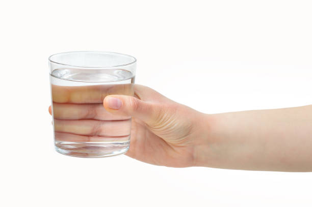 istock hand holding a water glass 1138821229