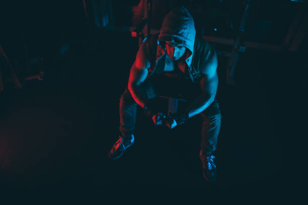 istock Strong man concentrating for weightlifting in dark gym 1138821356