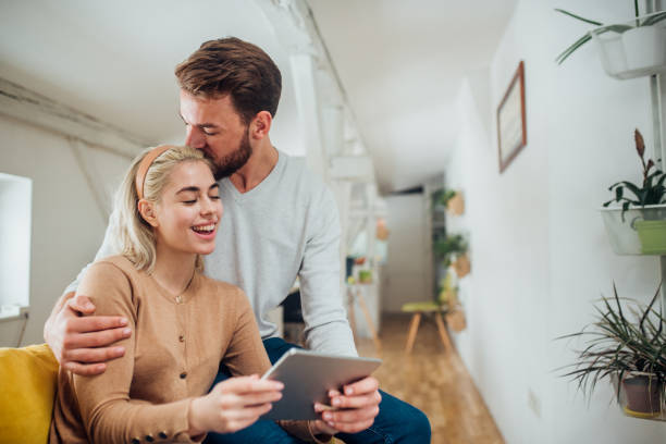 istock Man kissing woman using digital tablet 1138821506