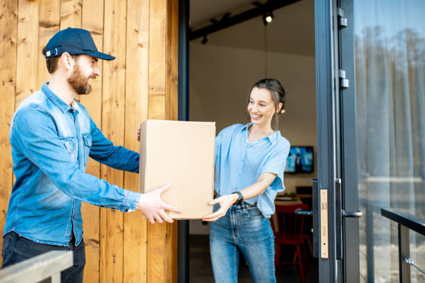 istock Delivery man bringing goods home for a woman client 1138822938