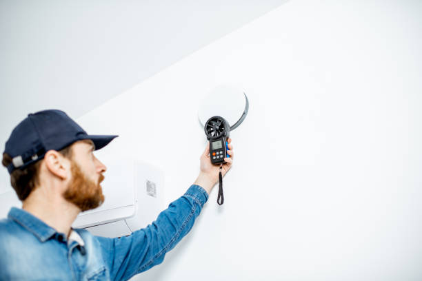 Handyman checking of air ventilation Handyman checking the speed of air ventilation with measuring tool on the white wall background windspeed stock pictures, royalty-free photos & images