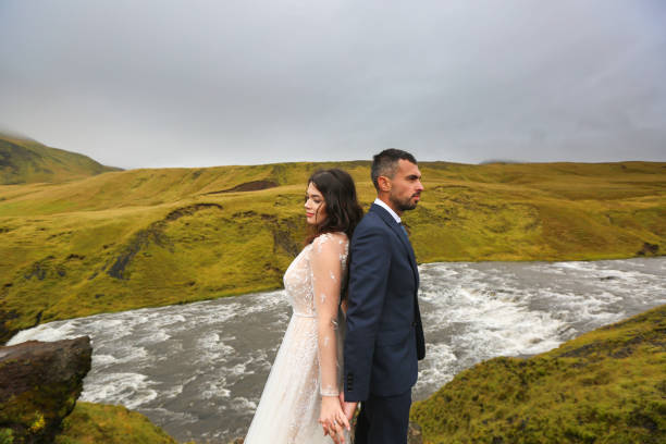 istock Beautiful wedding couple posing with waterfall 1138824148
