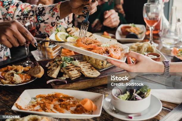 Sharing Is Caring Stock Photo - Download Image Now - Restaurant, Friendship, Dinner