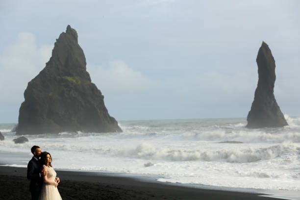 istock Beautiful wedding couple posing on beach 1138824252