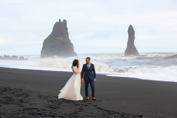 istock Beautiful wedding couple posing on beach 1138824267