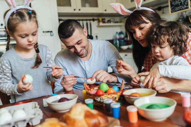 istock Happy family painting Easter eggs 1138824294