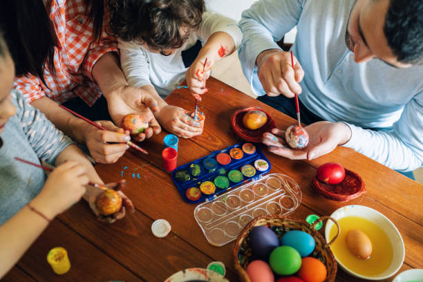 istock Happy family painting Easter eggs 1138824300