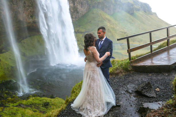 istock In love wedding couple posing near waterfall 1138824458