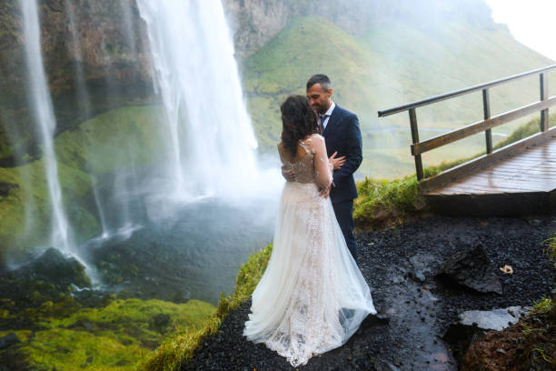 istock In love wedding couple posing near waterfall 1138824986