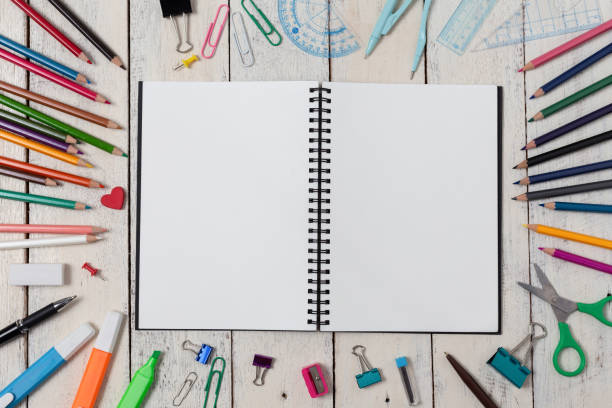 istock Empty notebook and colorful pencils on white wooden table 1138826741