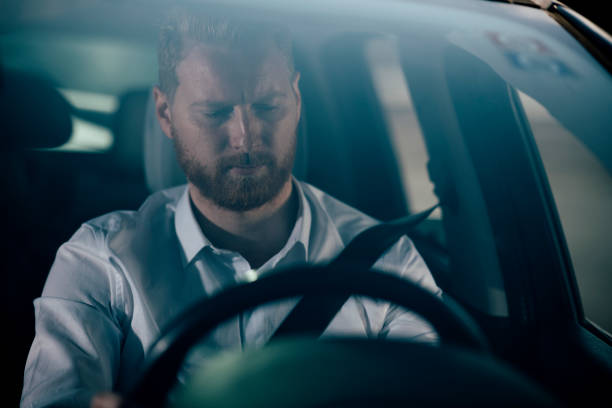 istock Sleepy businessman driving car 1138829896