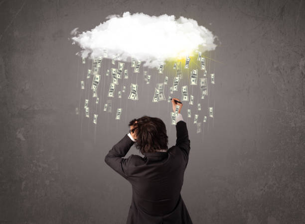 istock Business man in suit looking at cloud with falling money 1138831007