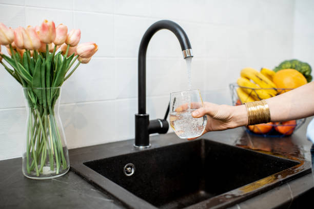 istock Woman filling tap water on the kitchen 1138831321