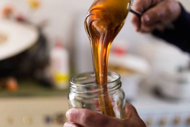 istock Pouring honey in the jar 1138831577