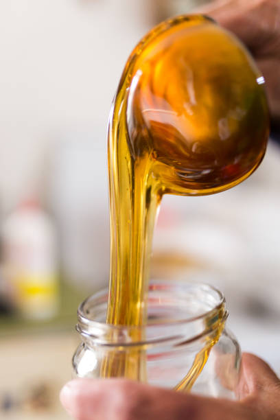 istock Pouring honey in the jar 1138831614
