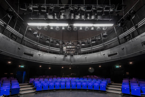 istock Blue seats in theather with large light equipment 1138831698