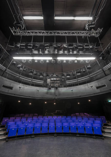 istock Blue seats in theather with large light equipment 1138831730