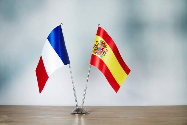 French and Spanish flag standing on the table